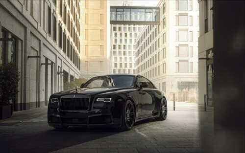 A close-up view of a luxurious black Rolls-Royce Wraith automobile parked in a sophisticated... 7680x4800 free wallpaper