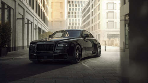 A close-up view of a luxurious black Rolls-Royce Wraith automobile parked in a sophisticated... 8K free background images