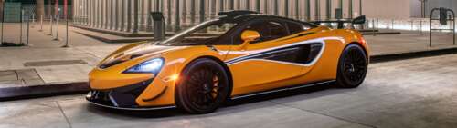 A sleek and vibrant orange McLaren 620R supercar highlighting its aerodynamic curves... Dual UHD computer backgrounds
