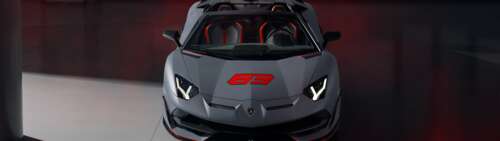 A sleek, metallic silver Lamborghini Aventador SVJ supercar featuring aggressive... Dual UHD free wallpaper