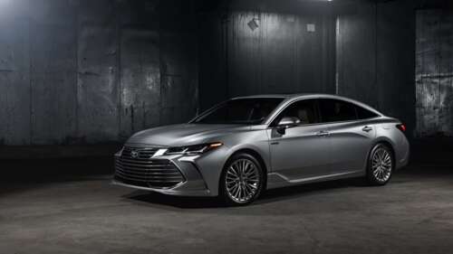 A close-up shot of a silver Toyota Avalon sedan with a metallic finish. 4K (Ultra HD) hd background