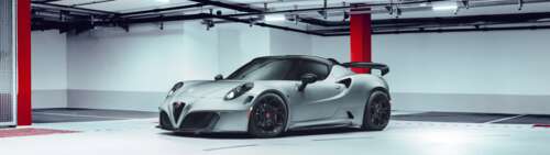 A close-up view of a sleek Alfa Romeo 4C sports car highlighting its aerodynamic... Dual UHD wallpaper