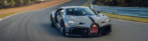 A detailed view of a Bugatti Chiron Pur Sport supercar featuring its iconic aerodynamic... free background