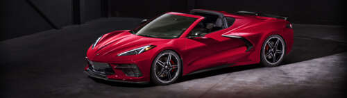 A high-performance Chevrolet Corvette C18 sports car showcasing its aerodynamic design. Dual UHD free wallpaper for computer