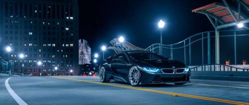A sleek BMW i8 supercar parked on a dark street at night, featuring glowing headlights... wallpaper download