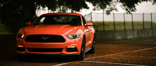 A classic Ford Mustang muscle car featuring its signature aggressive automotive design. wallpaper