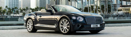 A premium black Bentley Continental GT Cabriolet featuring a glossy exterior and... Dual UHD wallpaper images