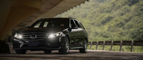 A glossy black Mercedes-Benz E-Class luxury sedan. UWUHD free wallpaper for computer