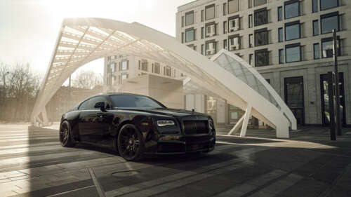 A luxurious black Rolls-Royce Wraith with a glossy finish and elegant automotive... free hd wallpapers