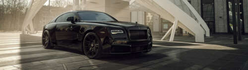 A luxurious black Rolls-Royce Wraith with a glossy finish and elegant automotive... Dual UHD background images hd