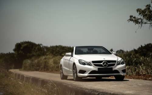 A luxurious white Mercedes-Benz E-Class convertible car. 7680x4800 hd background