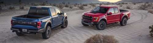 A Ford F-150 Raptor truck driving through a sandy desert landscape under bright sunlight. Dual UHD wallpaper photo gallery download