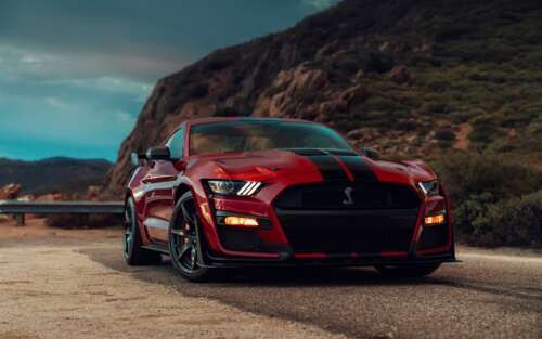 A high-performance Ford Mustang Shelby GT500 muscle car showcasing its muscular design... 7680x4800 wallpaper