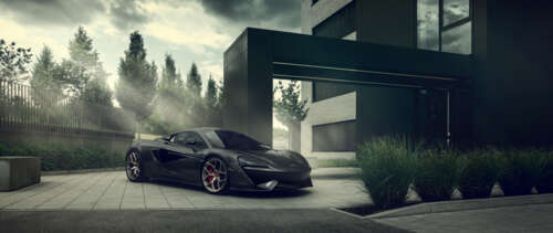 A sleek, black McLaren 570S supercar with a glossy finish and aerodynamic design. UWUHD free hd wallpapers