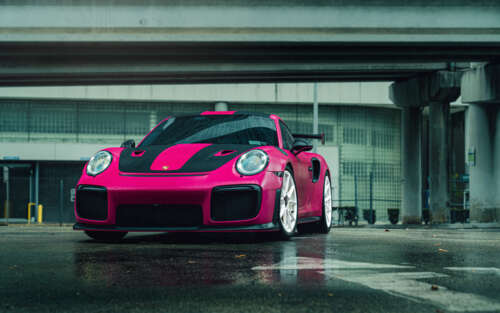A vibrant pink Porsche 911 GT2 RS luxury sports car 7680x4800 high definition wallpaper