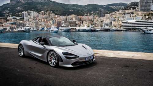 A polished silver McLaren 720S supercar parked on a scenic street in Monaco. 4K (Ultra HD) wallpaper for laptop download