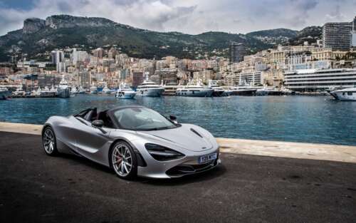 A polished silver McLaren 720S supercar parked on a scenic street in Monaco. 7680x4800 wallpaper photo gallery download