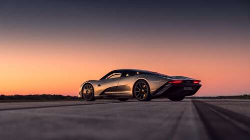 A silver McLaren Speedtail supercar parked under a beautiful sunset sky. 8K pictures for wallpaper