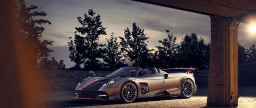 A sleek, silver Pagani Huayra supercar featuring a polished metallic finish and aerodynamic... free wallpaper