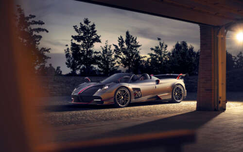 A sleek, silver Pagani Huayra supercar featuring a polished metallic finish and aerodynamic... 7680x4800 wallpaper download