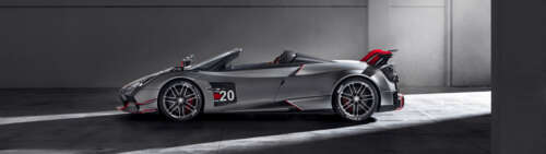 A high-detail shot of a polished silver Pagani Huayra supercar. wallpaper