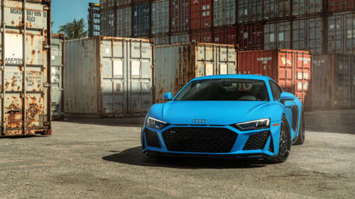 A detailed shot of a sleek Audi R8 supercar featuring its iconic aerodynamic design... 4K (Ultra HD) desktop wallpaper