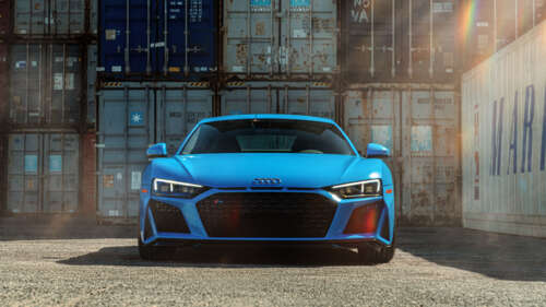 A close-up, high-detail shot of a premium Audi R8 supercar highlighting its sleek... 8K high definition wallpaper