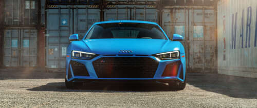 A close-up, high-detail shot of a premium Audi R8 supercar highlighting its sleek... UWUHD free wallpaper for computer