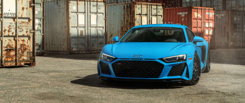 A detailed shot of a sleek Audi R8 supercar featuring its iconic aerodynamic design... UWUHD hd background