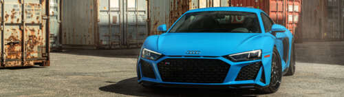 A detailed shot of a sleek Audi R8 supercar featuring its iconic aerodynamic design... Dual UHD wallpaper download
