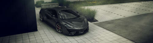 A glossy black McLaren 570S supercar showcasing its sleek aerodynamic body. Dual UHD hd background