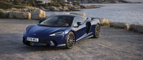 A high-resolution close-up of a sleek McLaren GT supercar highlighting its aerodynamic... UWUHD free background images