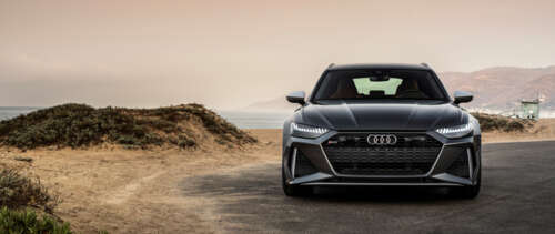 A close-up view of a metallic silver Audi RS6 Avant displaying its sleek and aerodynamic... UWUHD free wallpaper
