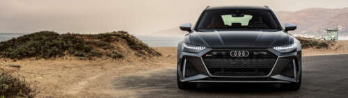 A close-up view of a metallic silver Audi RS6 Avant displaying its sleek and aerodynamic... Dual UHD ps4 wallpaper