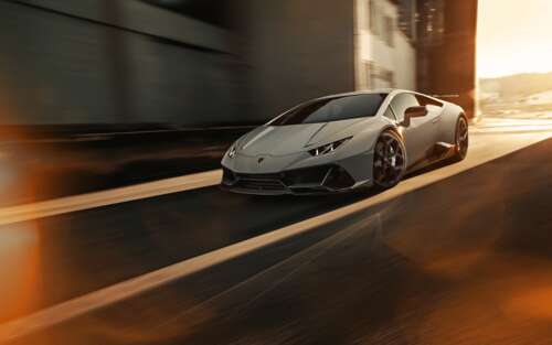 A sleek silver Lamborghini Huracan Evo supercar showcasing its aerodynamic design... 7680x4800 wallpaper for laptop download