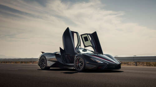 A close-up view of a sleek, black SSC Tuatara hypercar showcasing its aerodynamic... wallpaper