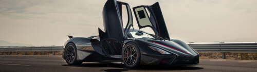 A close-up view of a sleek, black SSC Tuatara hypercar showcasing its aerodynamic... Dual UHD wallpaper images