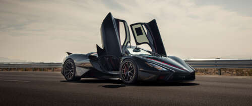 A close-up view of a sleek, black SSC Tuatara hypercar showcasing its aerodynamic... UWUHD ps4 wallpaper