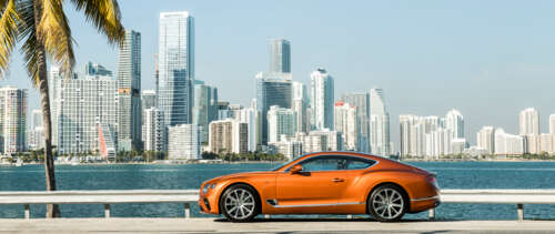 A premium orange Bentley Continental GT showcasing its luxurious design and vibrant... UWUHD computer backgrounds