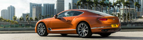 A luxurious orange Bentley Continental GT showcasing its sleek design and vibrant... free hd wallpapers