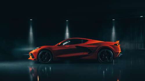 A sleek and vibrant orange Chevrolet Corvette C8 supercar highlighting its mid-engine... 4K (Ultra HD) ps4 wallpaper