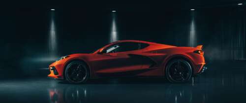 A sleek and vibrant orange Chevrolet Corvette C8 supercar highlighting its mid-engine... UWUHD wallpaper for pc download