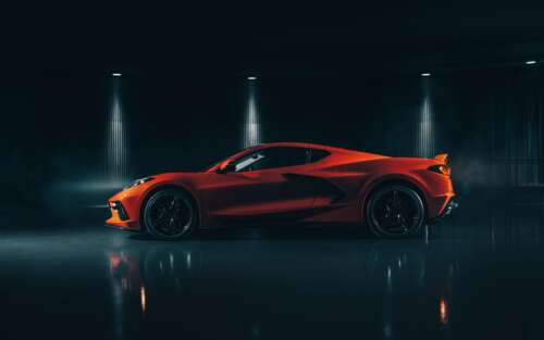 A sleek and vibrant orange Chevrolet Corvette C8 supercar highlighting its mid-engine... 7680x4800 free background images