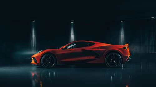 A sleek and vibrant orange Chevrolet Corvette C8 supercar highlighting its mid-engine... 8K