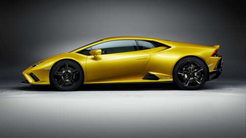 A sleek and bright yellow Lamborghini Huracán Evo supercar showcasing its aerodynamic... 4K (Ultra HD) wallpaper images