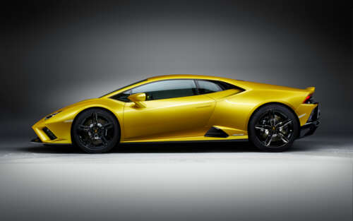A sleek and bright yellow Lamborghini Huracán Evo supercar showcasing its aerodynamic... 7680x4800 ps4 wallpaper