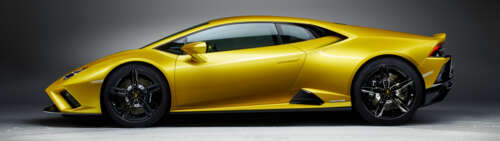 A sleek and bright yellow Lamborghini Huracán Evo supercar showcasing its aerodynamic... Dual UHD computer backgrounds