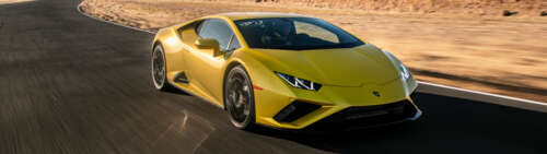 A sleek, bright yellow Lamborghini Huracán Evo showcasing its aerodynamic supercar... Dual UHD wallpaper photo gallery download