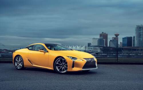 A bright yellow Lexus LC 500 luxury sports car showcasing its sleek, aerodynamic... wallpaper download