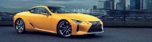 A bright yellow Lexus LC 500 luxury sports car showcasing its sleek, aerodynamic... Dual UHD free hd wallpapers